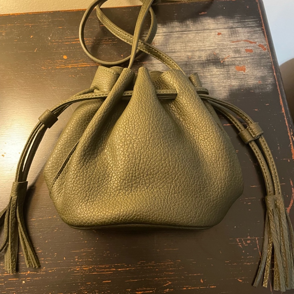 Crossbody bucket bag with fringe on both sides. Great Condition. Dark green.
